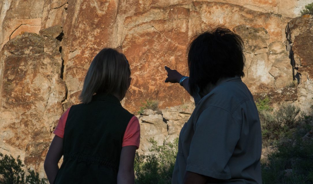 People look at petroglyphs at Freemont State Park